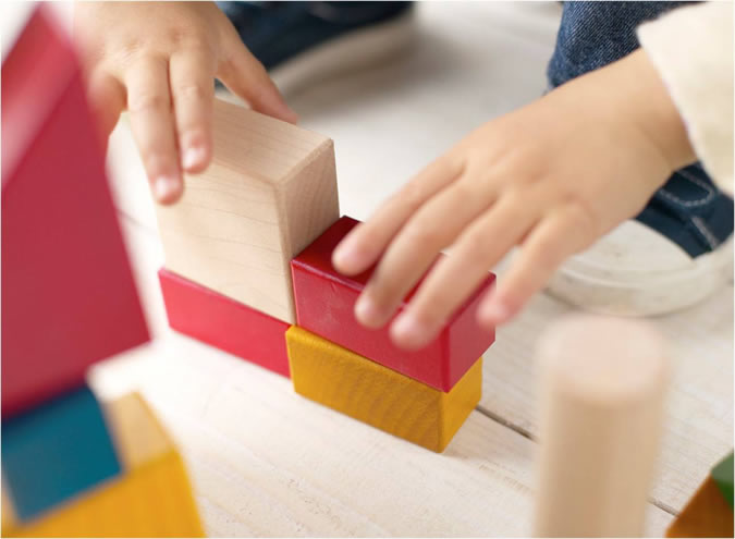 Child Playing with Toy Blocks